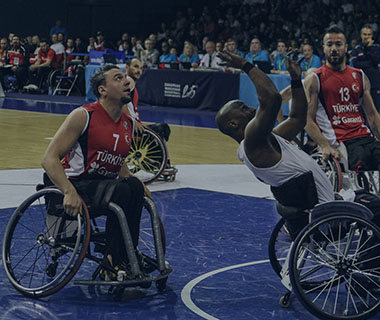 Men are playing wheelchair basketball